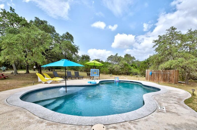 Inground pool with with built-in steps & blue umbrella