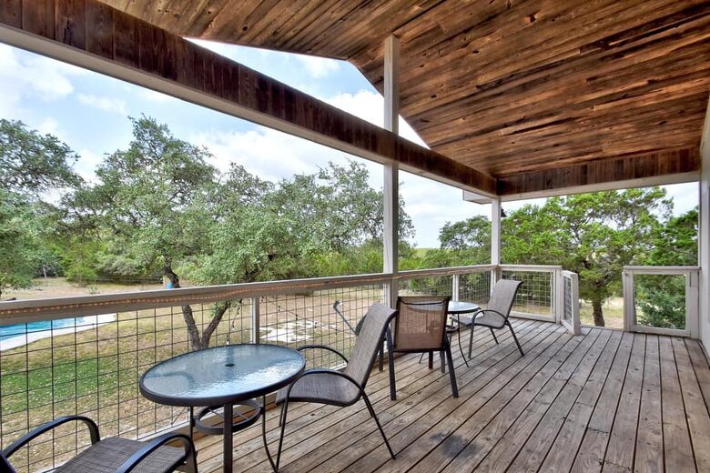 Retreat balcony with tables & chairs overlooking the pool
