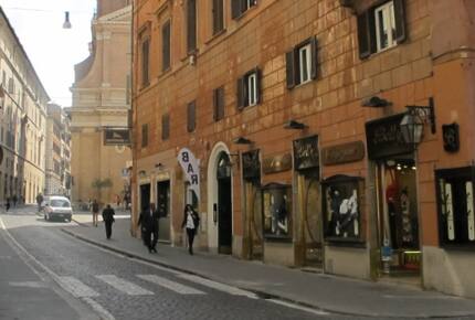 Our street, with wide sidewalks, bars, cafes, a local church