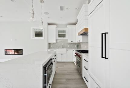 Home exchange in Newport Beach CA, elongated all-white kitchen