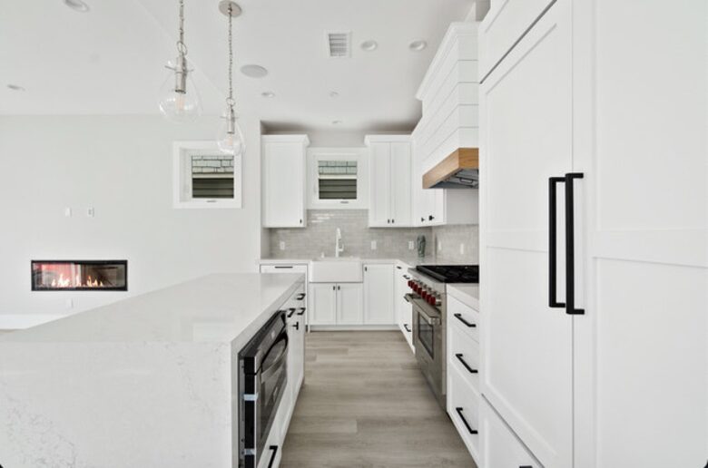 Home exchange in Newport Beach CA, elongated all-white kitchen