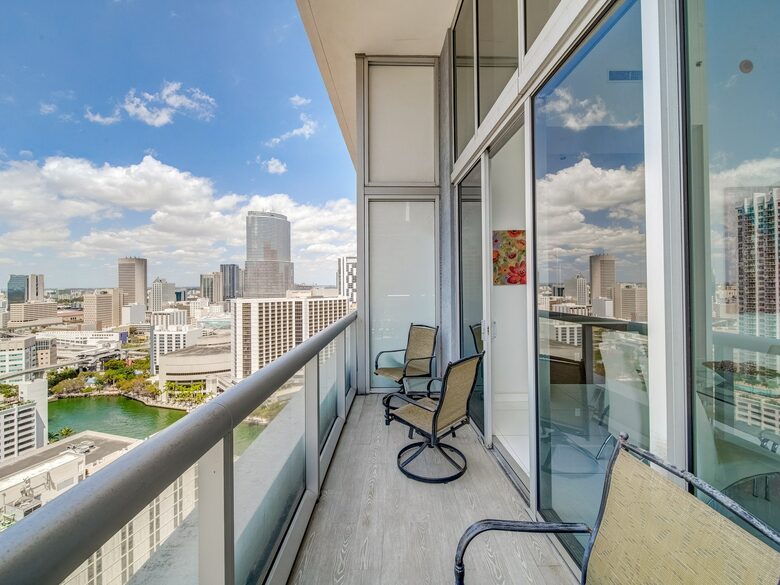 Home exchange in Miami FL, balcony with chairs overlooking the city