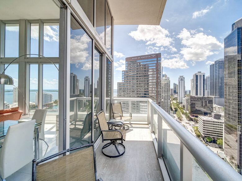 Home exchange in Miami FL, balcony with chairs overlooking the city
