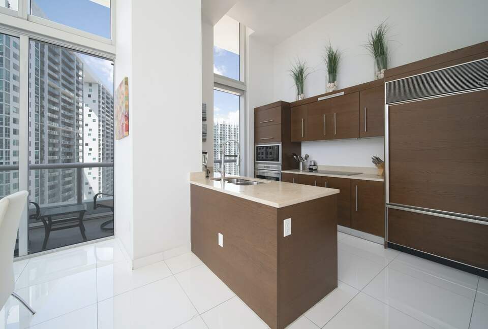Home exchange in Miami FL, kitchen with brown cabinetry