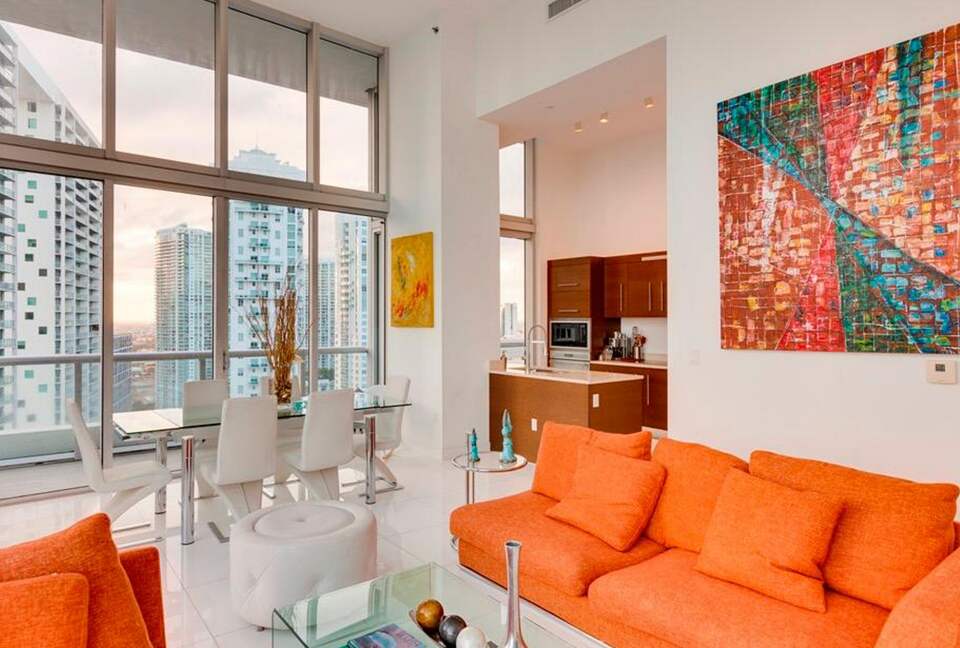 Home exchange in Miami FL, living room with orange couch