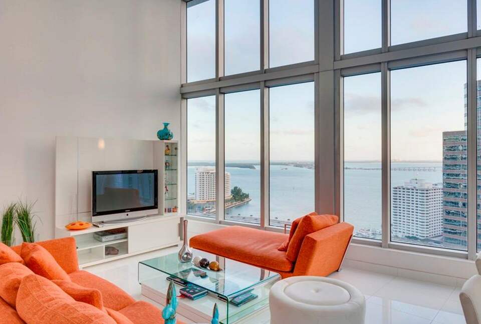 Home exchange in Miami FL, living room with 16 foot windows