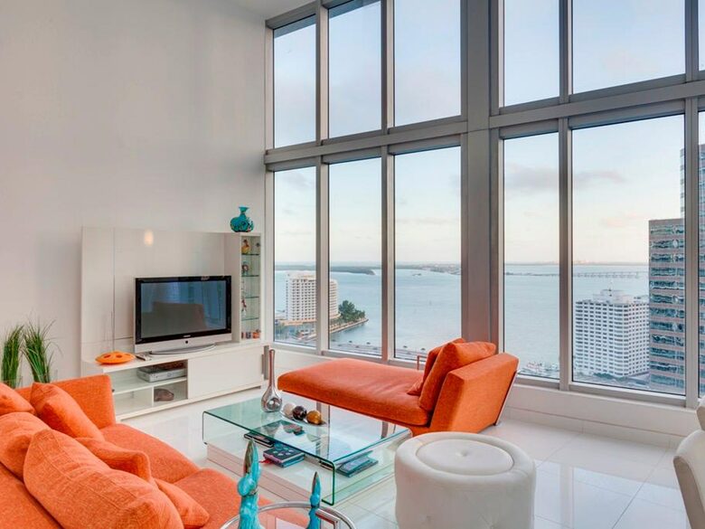 Home exchange in Miami FL, living room with 16 foot windows