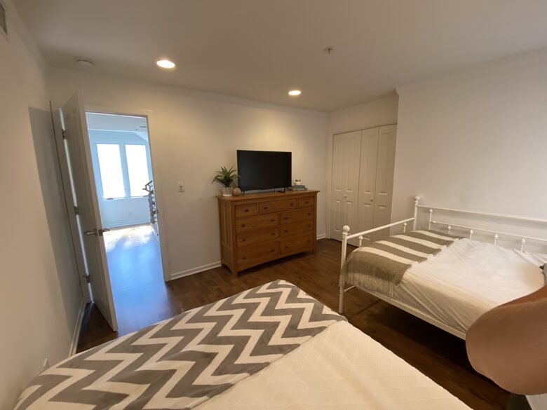 2nd Floor Bedroom with 2 double beds, TV & adjacent bathroom