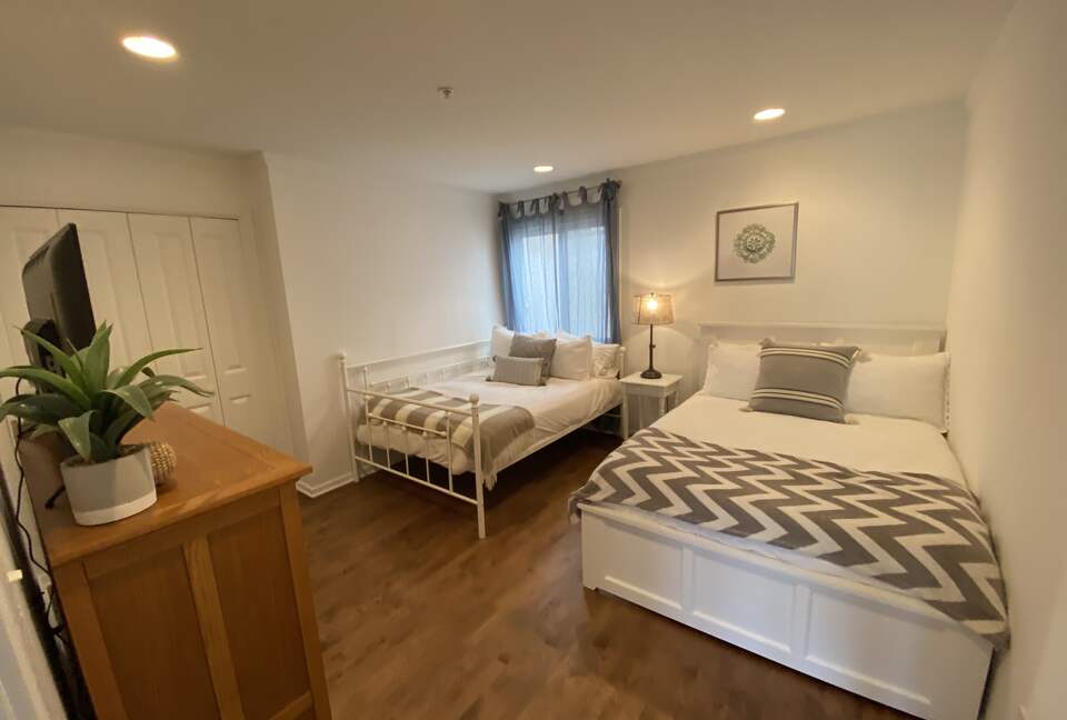 2nd Floor Bedroom with 2 double beds, TV & adjacent bathroom