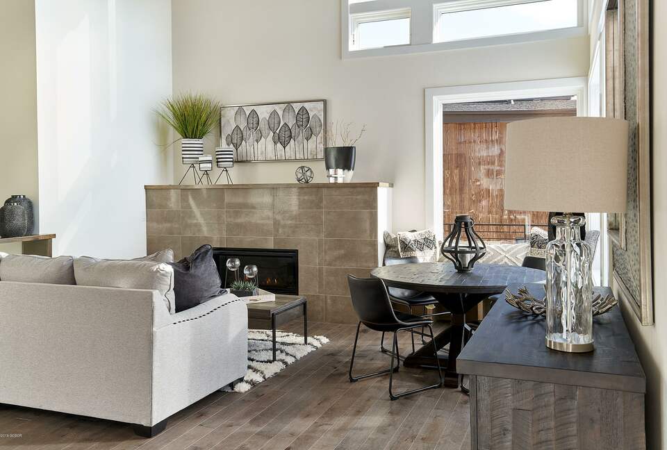 Home exchange in Fraser CO, living room with fireplace & beige couch