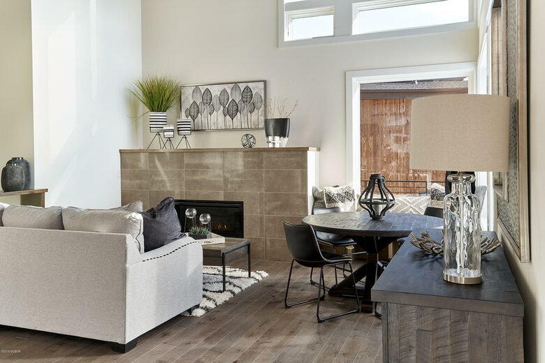 Home exchange in Fraser CO, living room with fireplace & beige couch