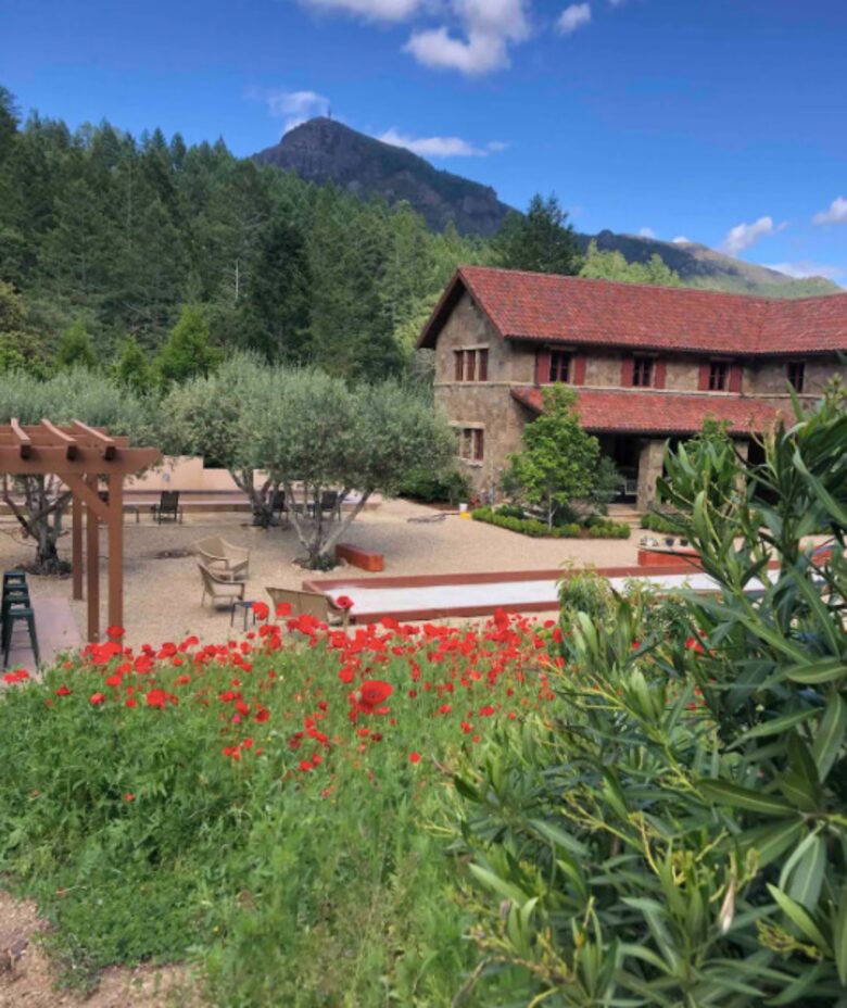Home exchange in Calistoga CA with red flowers and a bocce ball court