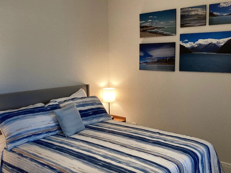 Home exchange in Cape Coral FL, bedroom with queen bed & striped sheet