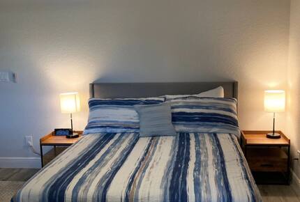 Home exchange in Cape Coral FL, bedroom with queen bed & striped sheet