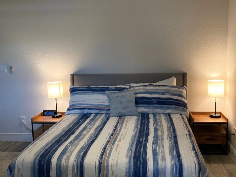 Home exchange in Cape Coral FL, bedroom with queen bed & striped sheet