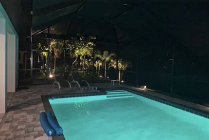 Home exchange in Cape Coral FL, enclosed saltwater pool at night