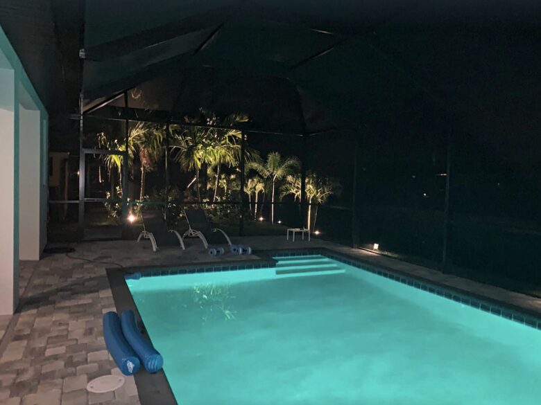 Home exchange in Cape Coral FL, enclosed saltwater pool at night