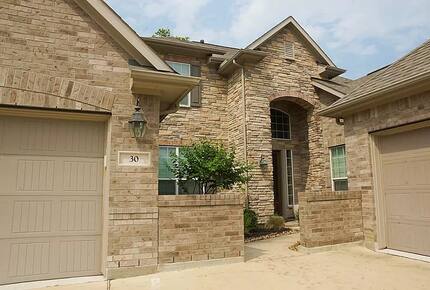 Home exchange in Woodlands TX with stone-front elevation