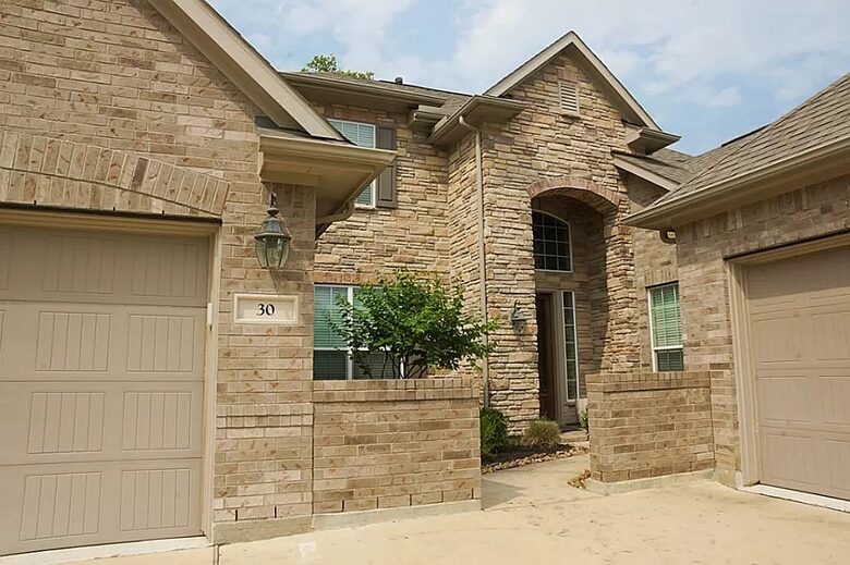 Home exchange in Woodlands TX with stone-front elevation