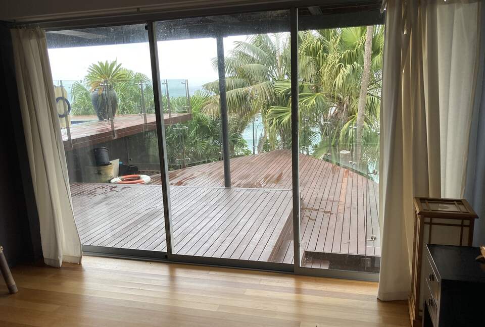 Relax among the palms on the deck off third bedroom