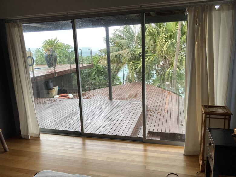 Relax among the palms on the deck off third bedroom