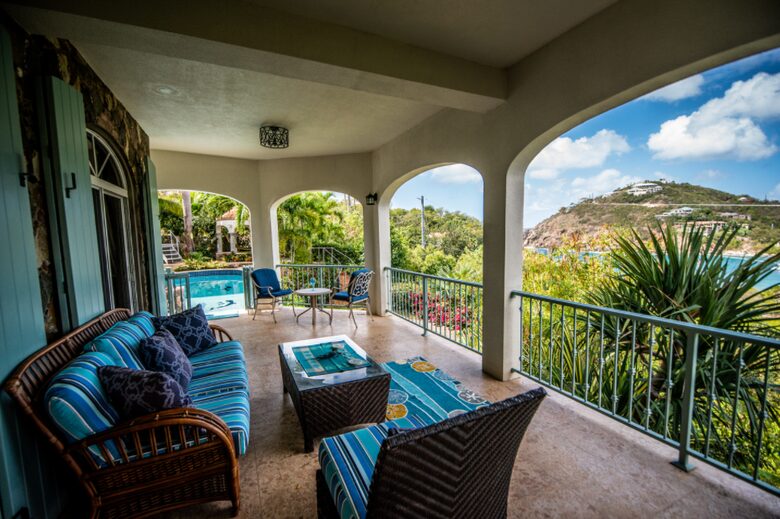 Home exchange in St John USVI, shared balcony with blue cushion seats