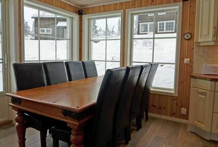 Dinner table and part of the kitchen.