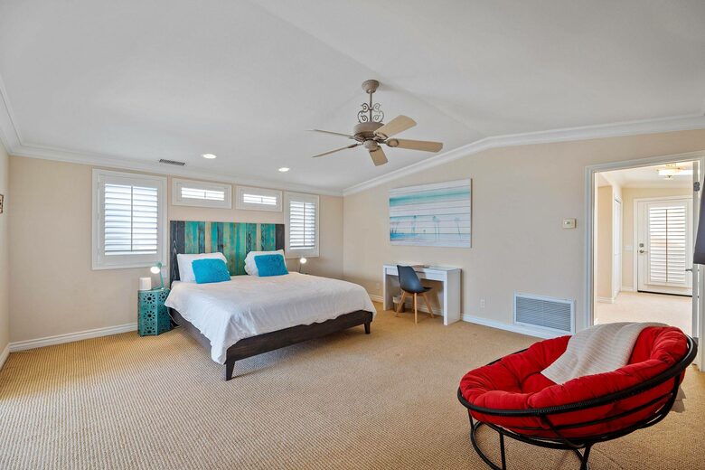 Home exchange in Oxnard CA, master bedroom with tufted papsan chair