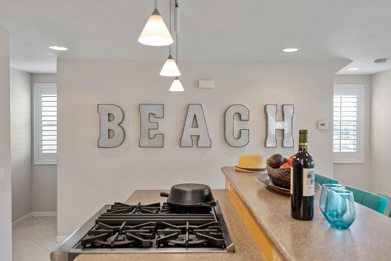 Home exchange in Oxnard CA with galvanized "beach" letter wall decor