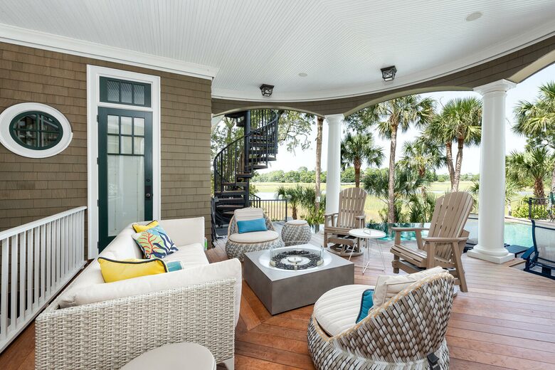 sitting area with fire pit overlooking pool and marsh
