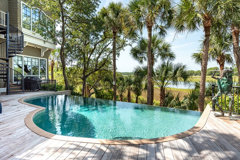 infinity pool overlooking vast marsh and river
