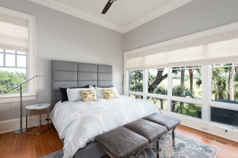 guest bedroom overlooking pool and marsh
