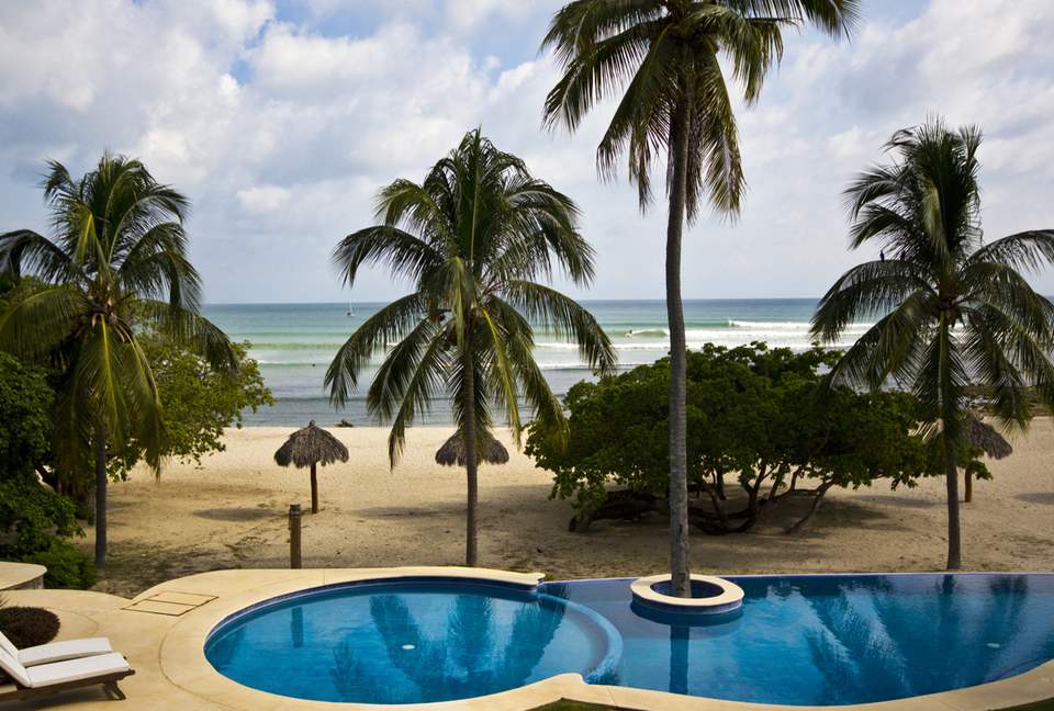 view looking over edge of our Patio at pool and ocean