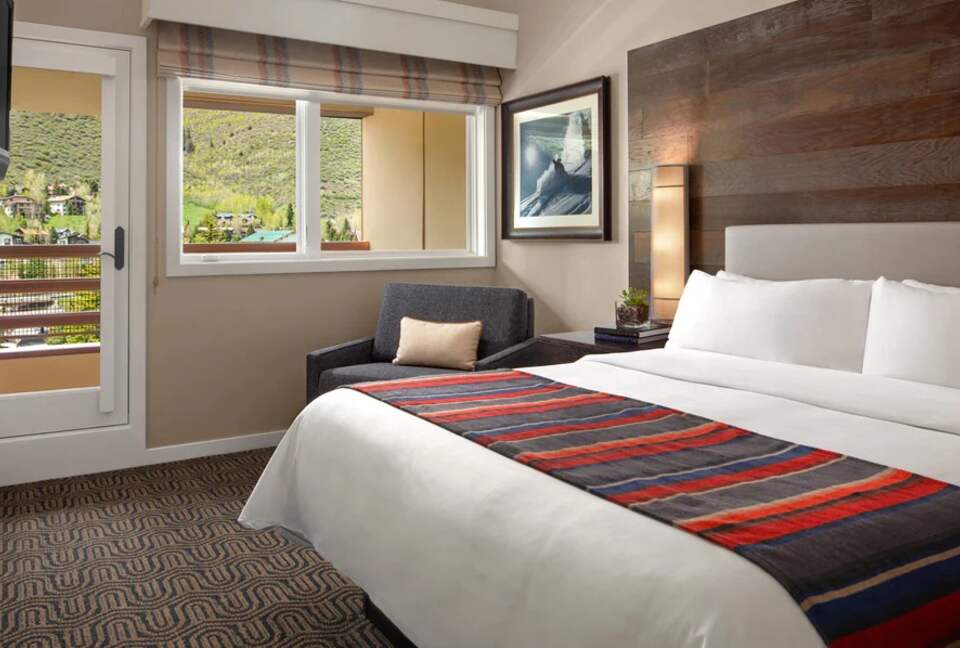 Master bedroom with balcony and mountain views
