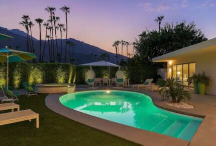 Home Exchange in Palm Springs, CA resort style pool at night