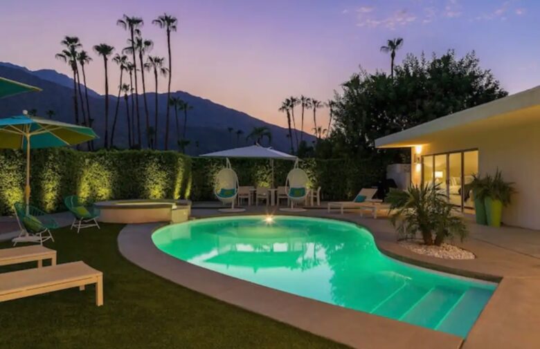 Home Exchange in Palm Springs, CA resort style pool at night