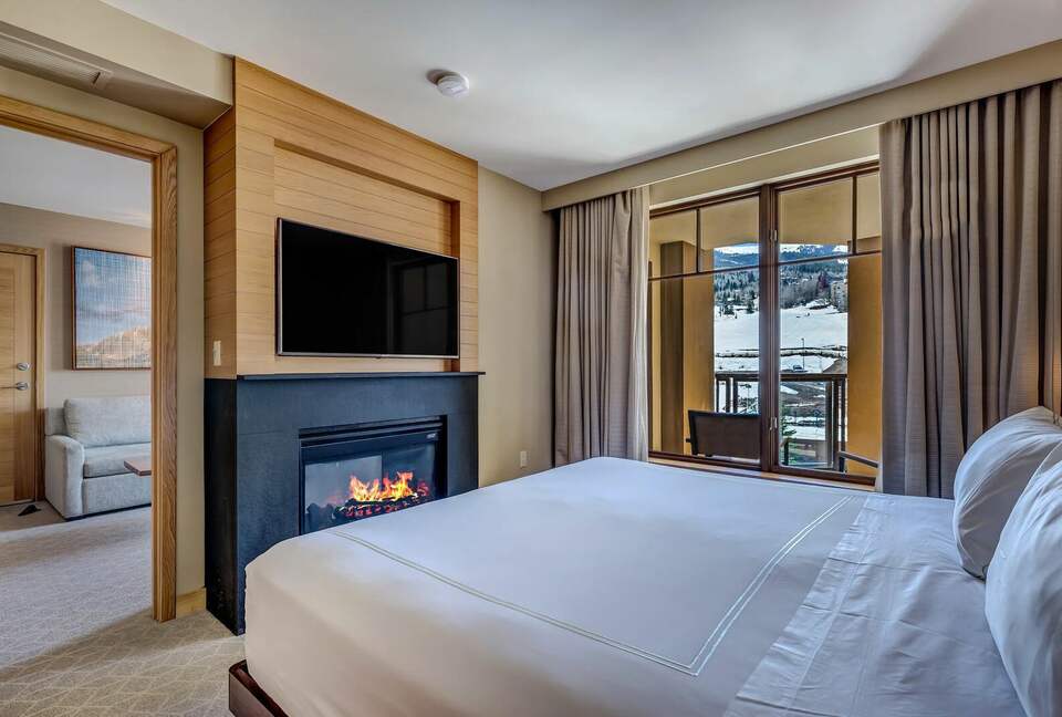 Master bedroom with fireplace and mountain views