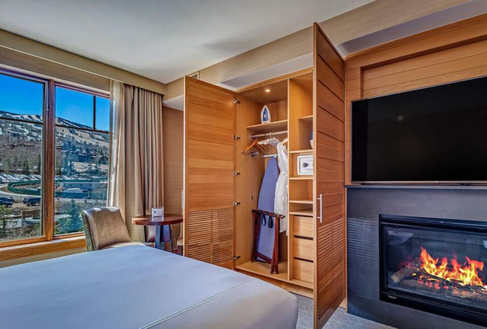Master bedroom with fireplace and mountain views