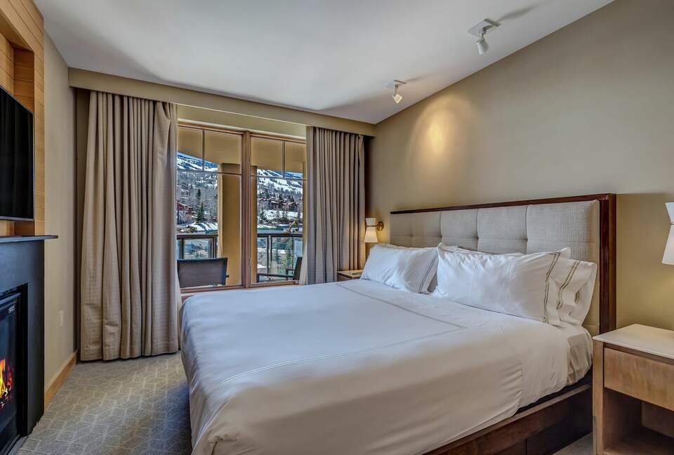 Master bedroom with fireplace and mountain views