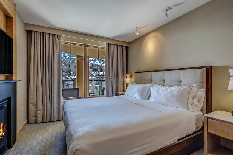 Master bedroom with fireplace and mountain views