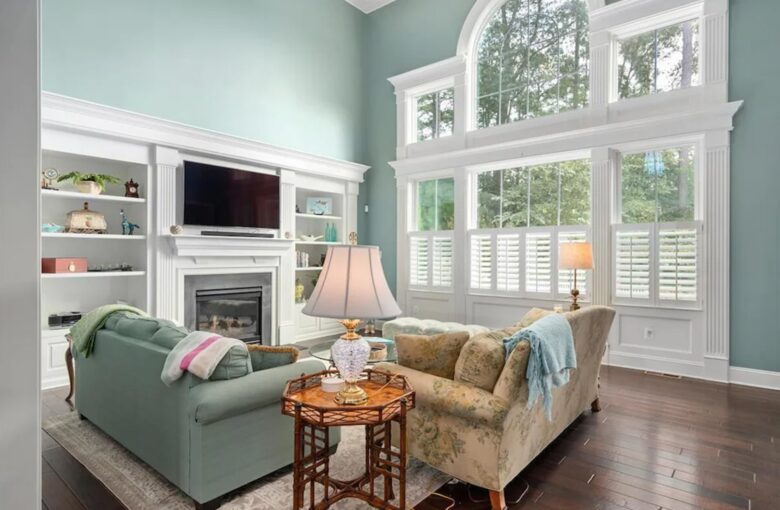 Spacious sun-filled living room with TV