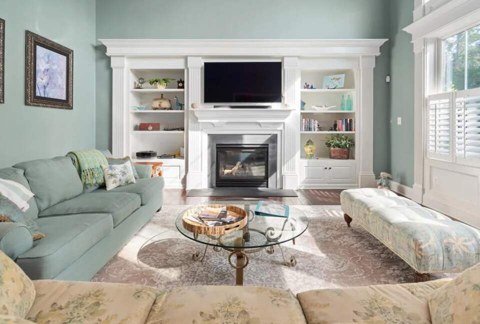 Spacious sun-filled living room with TV