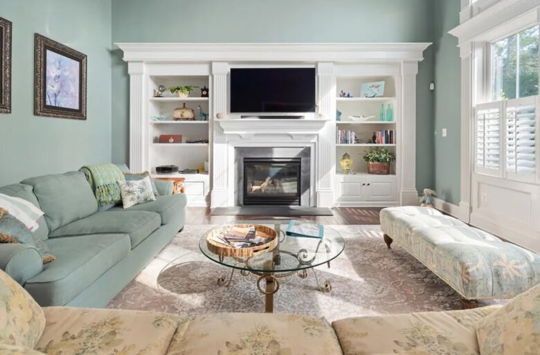 Spacious sun-filled living room with TV