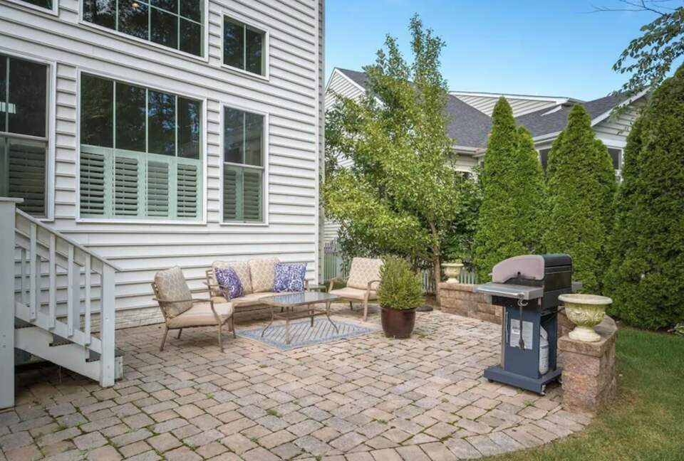 Backyard patio with sitting area and grill