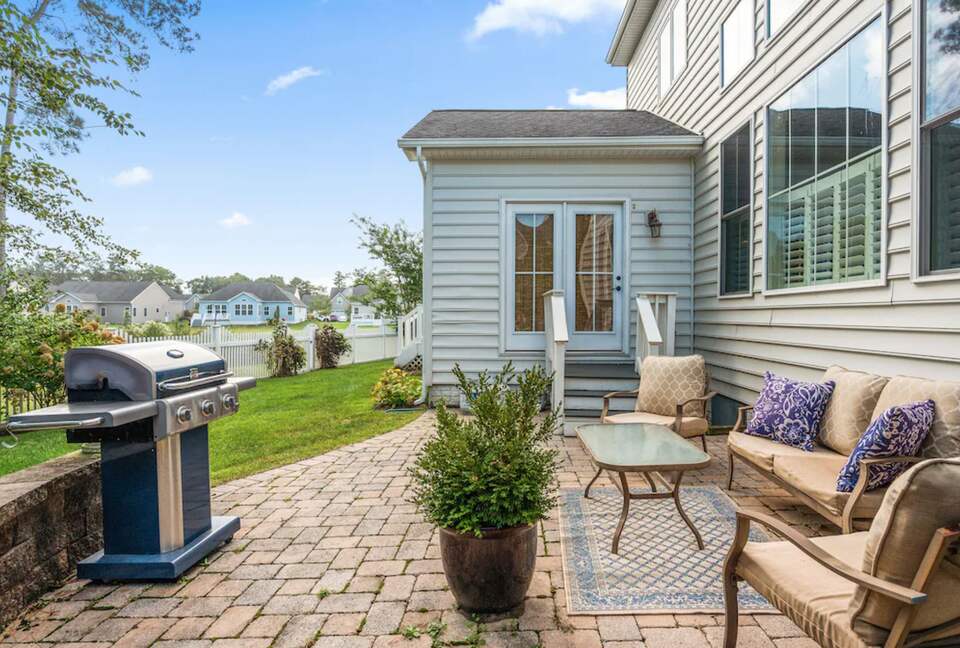 Backyard patio with sitting area and grill