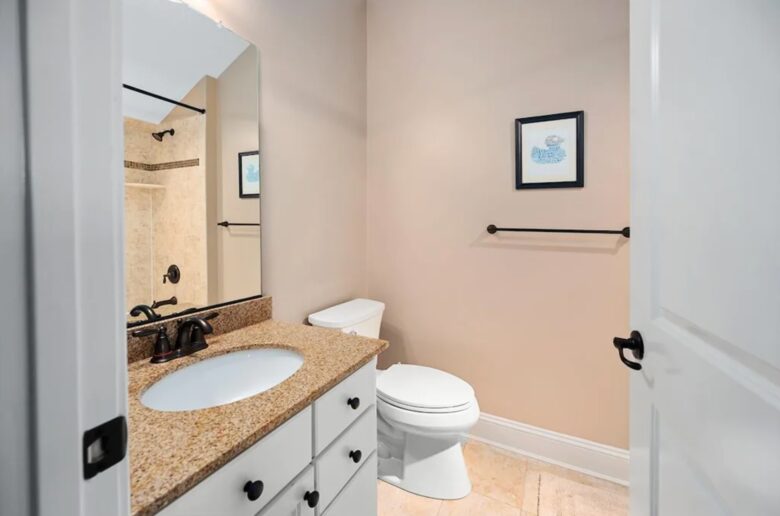 Secondary bathroom with tile floors and granite countertop