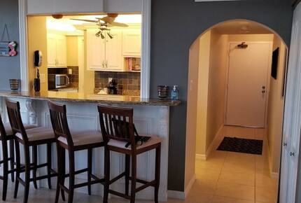 Home Exchange in Marco Island, FL kitchen with barstool seating