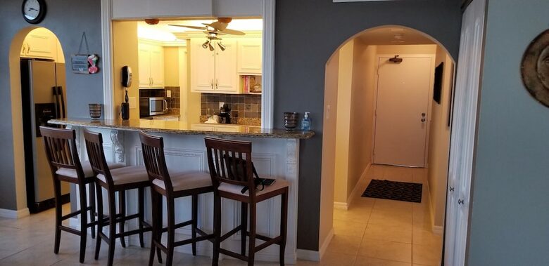 Home Exchange in Marco Island, FL kitchen with barstool seating
