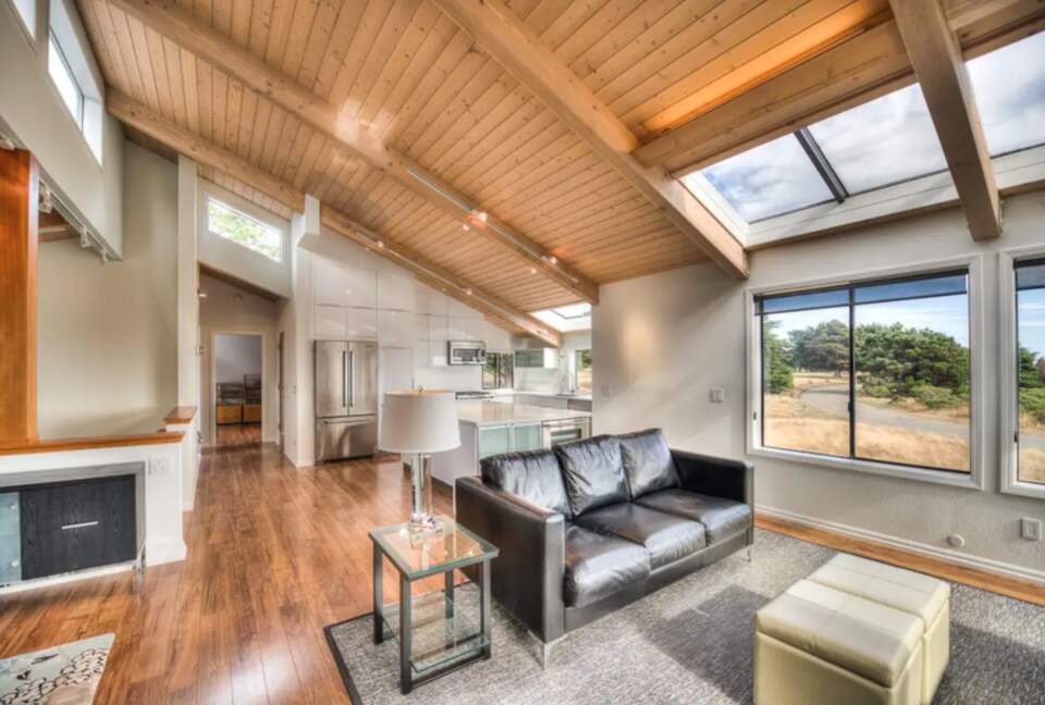 Open living and dining rooms with vaulted ceilings