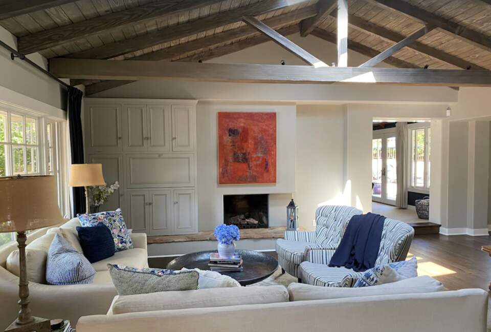Open living room with vaulted ceiling and exposed wood beams